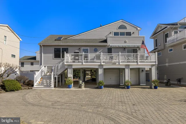 a view of a white building with large windows