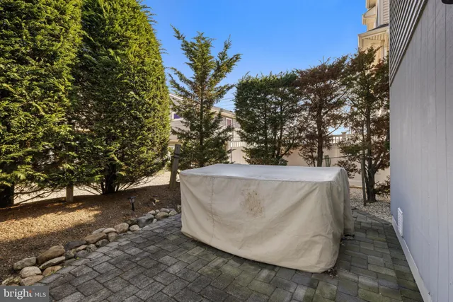 a view of a patio with table and chairs and potted plants