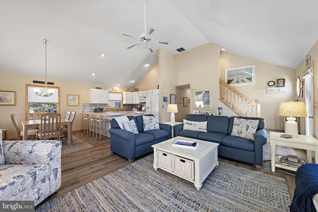 a living room with furniture and kitchen view