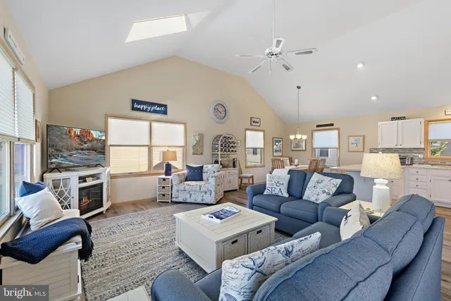 a living room with furniture kitchen view and a fireplace