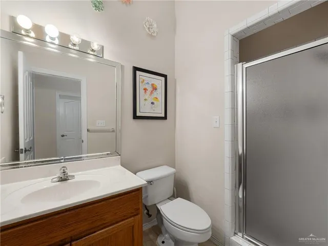 a bathroom with a toilet a sink and mirror
