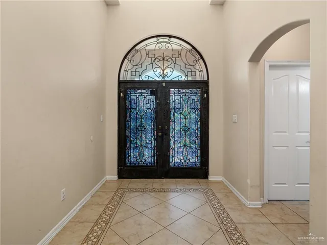 an empty room with windows mirror and door