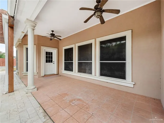 a view of an empty room with a window and a fireplace