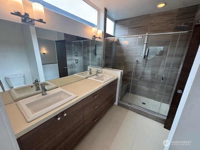 4503 15th Avenue South, Unit B Seattle, WA 98108 - Photo 19 of 25 a bathroom with a sink mirror and shower