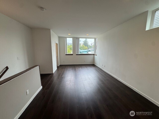4503 15th Avenue South, Unit B Seattle, WA 98108 - Photo 2 of 25 an empty room with wooden floor and windows