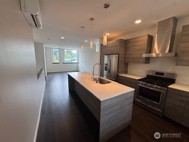 4503 15th Avenue South, Unit B Seattle, WA 98108 - Photo 3 of 25 a kitchen with stainless steel appliances a sink stove and cabinets