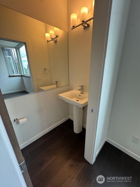 4503 15th Avenue South, Unit B Seattle, WA 98108 - Photo 7 of 25 a bathroom with a sink a toilet and mirror