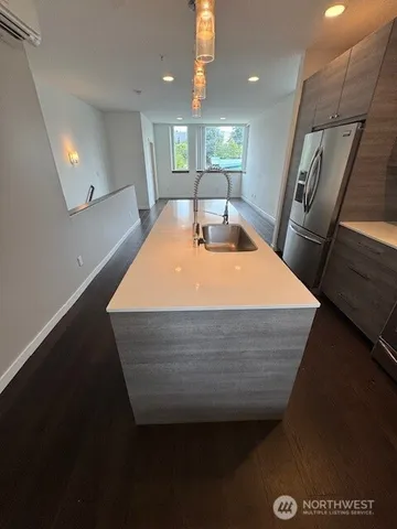 a view of entryway and hall with wooden floor