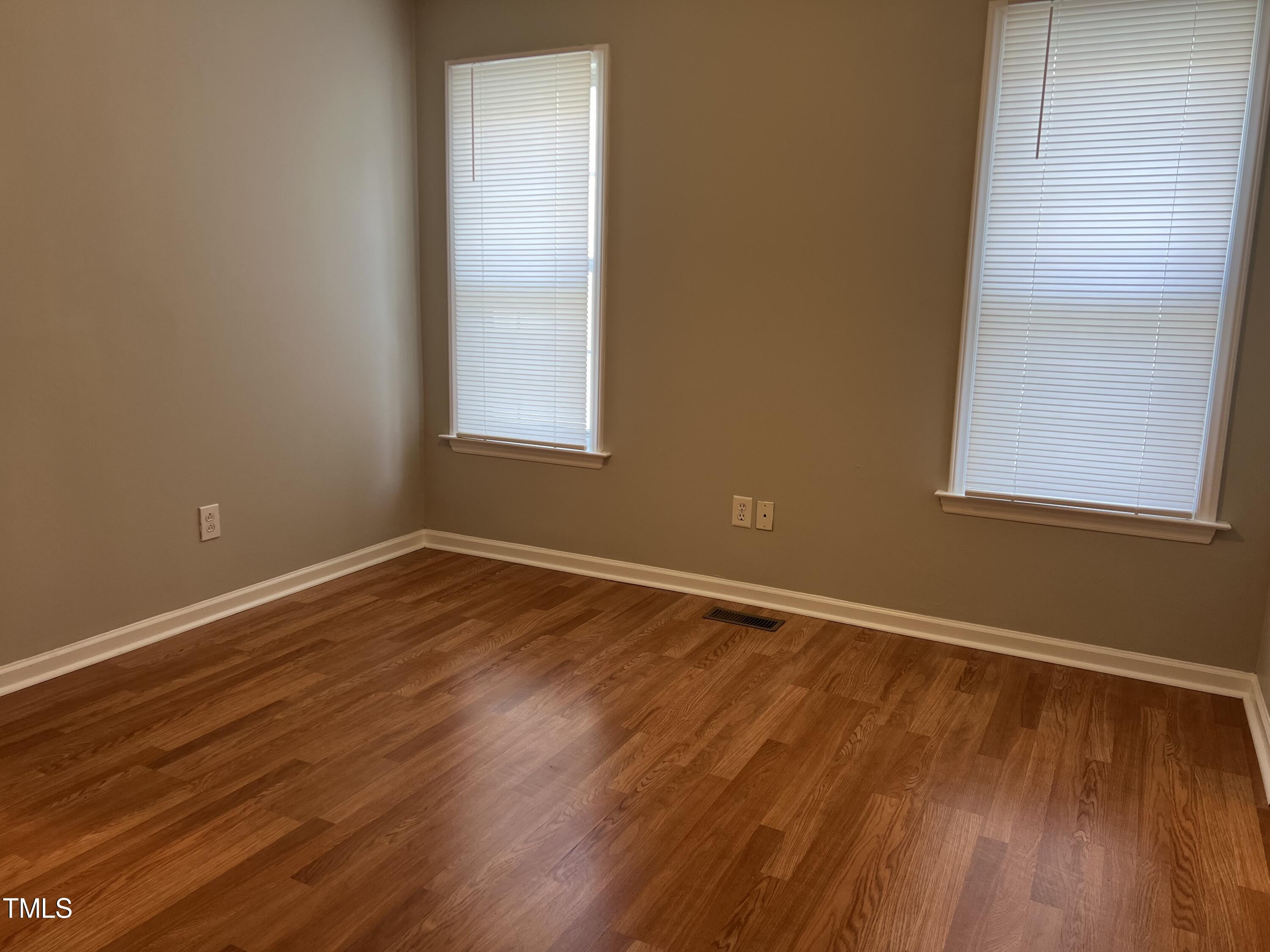 2032 Turtle Point Drive Raleigh, NC 27604 - Photo 12 of 18 a view of an empty room with wooden floor and a window