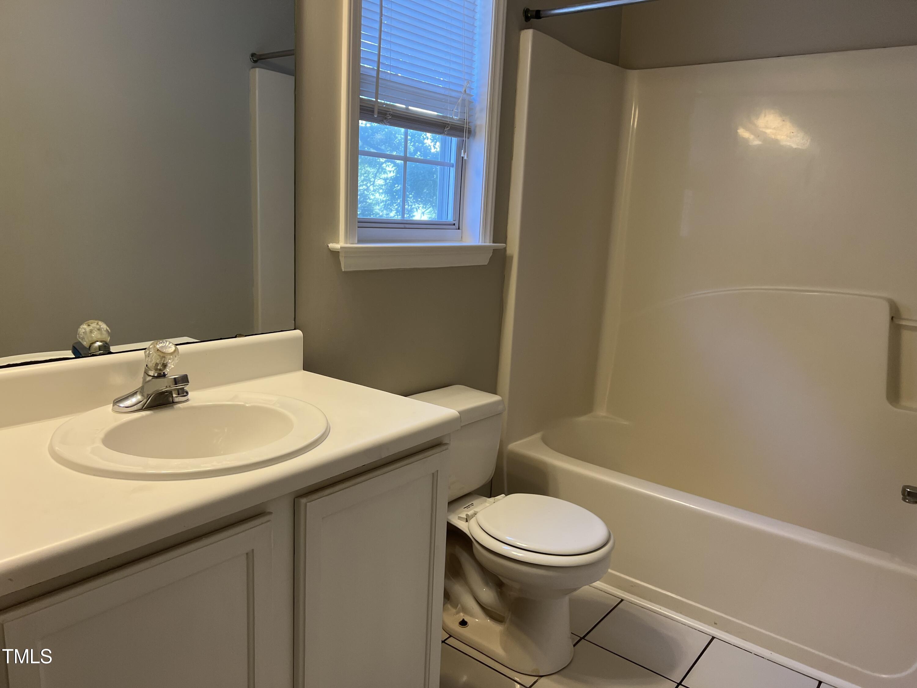 2032 Turtle Point Drive Raleigh, NC 27604 - Photo 13 of 18 a bathroom with a sink a toilet and tub