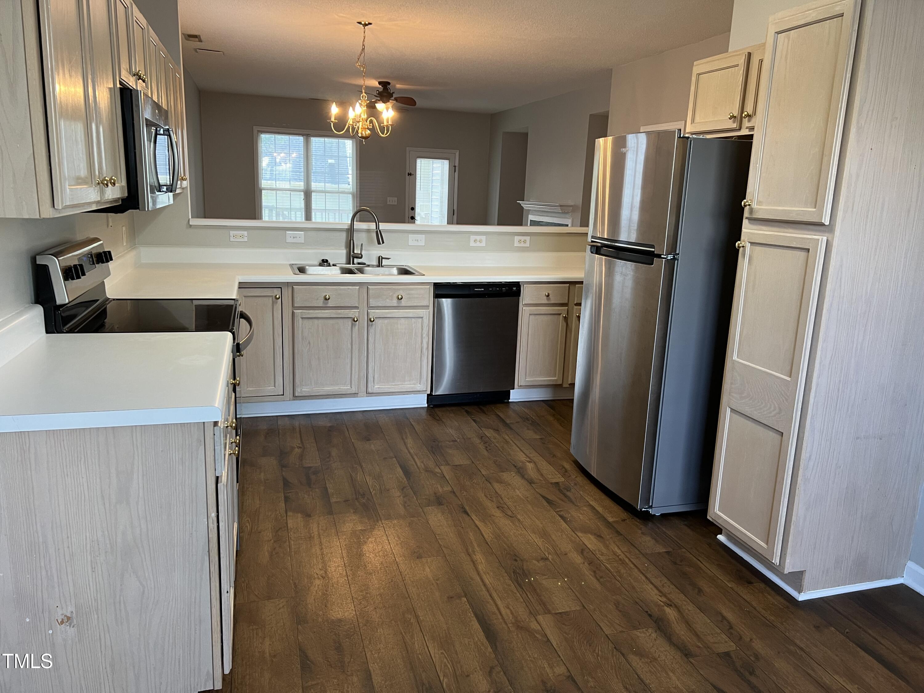 2032 Turtle Point Drive Raleigh, NC 27604 - Photo 7 of 18 a kitchen with stainless steel appliances a refrigerator a sink a stove a microwave and island