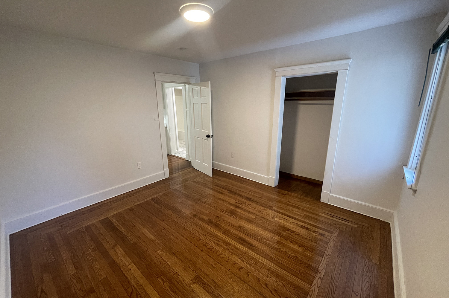 235 Russell Street, Unit 1 New Haven, CT 06513 - Photo 13 of 19 a view of an empty room with wooden floor and closet