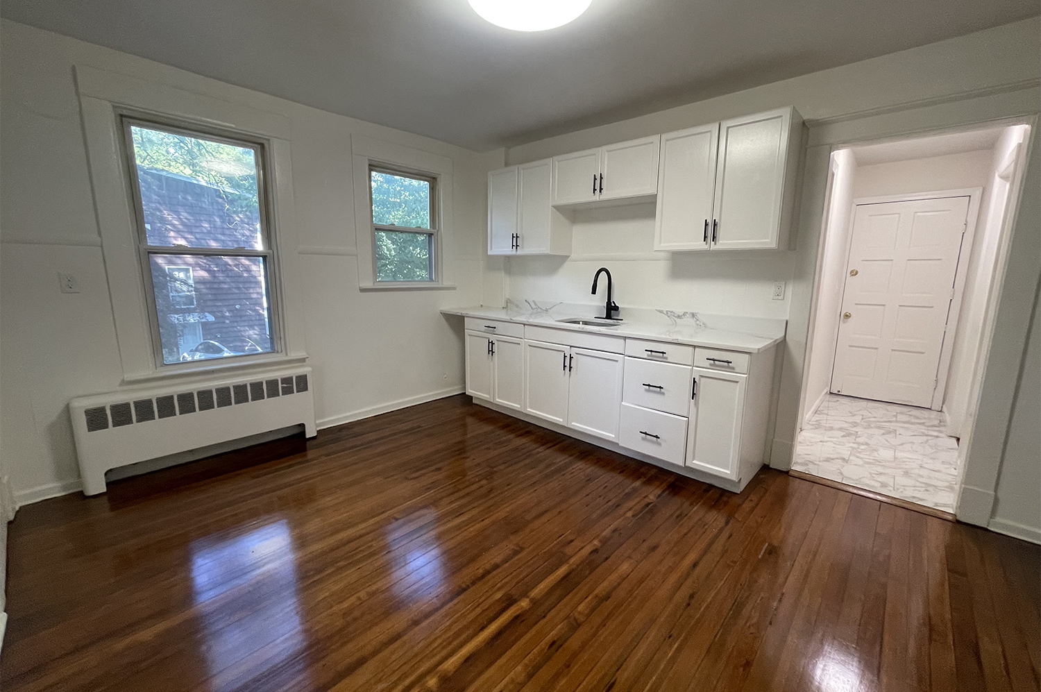235 Russell Street, Unit 1 New Haven, CT 06513 - Photo 4 of 19 a kitchen with wooden floors a stove and a window