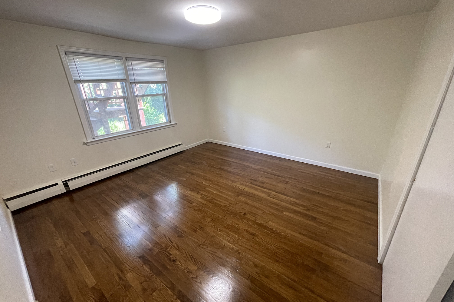 235 Russell Street, Unit 1 New Haven, CT 06513 - Photo 7 of 19 an empty room with wooden floor and windows
