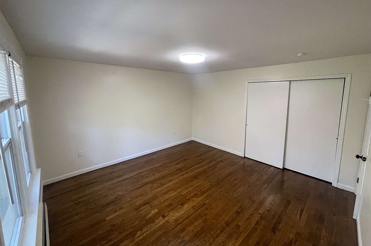 235 Russell Street, Unit 1 New Haven, CT 06513 - Photo 8 of 19 a view of empty room with wooden floor and fan