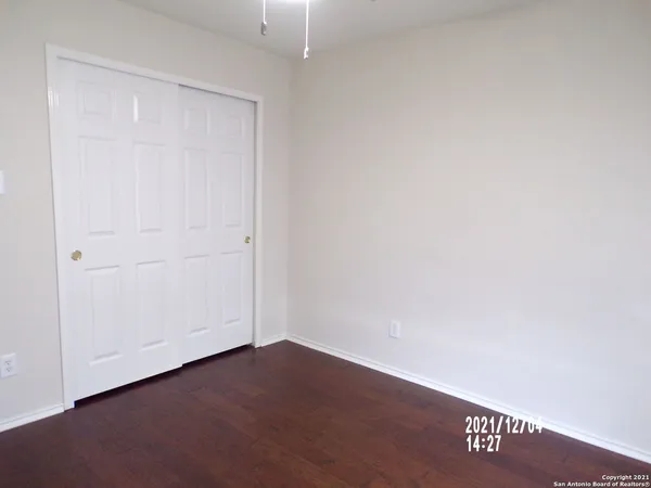 an empty room with wooden floor