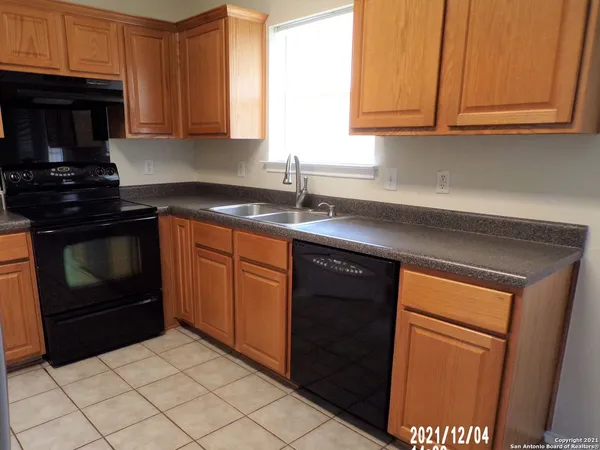 a kitchen with a refrigerator a stove a sink and dishwasher