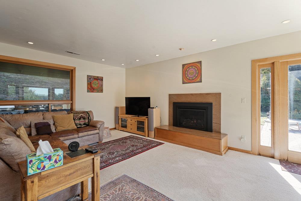 4760 Soquel Creek Road Soquel, CA 95073 - Photo 8 of 29 a living room with furniture a flat screen tv and a fireplace