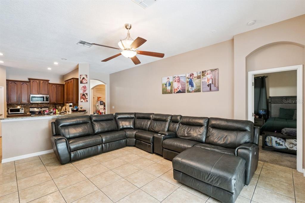8484 Dover View Lane Orlando, FL 32829 - Photo 8 of 41 a view of living room kitchen with kitchen island furniture and a ceiling fan