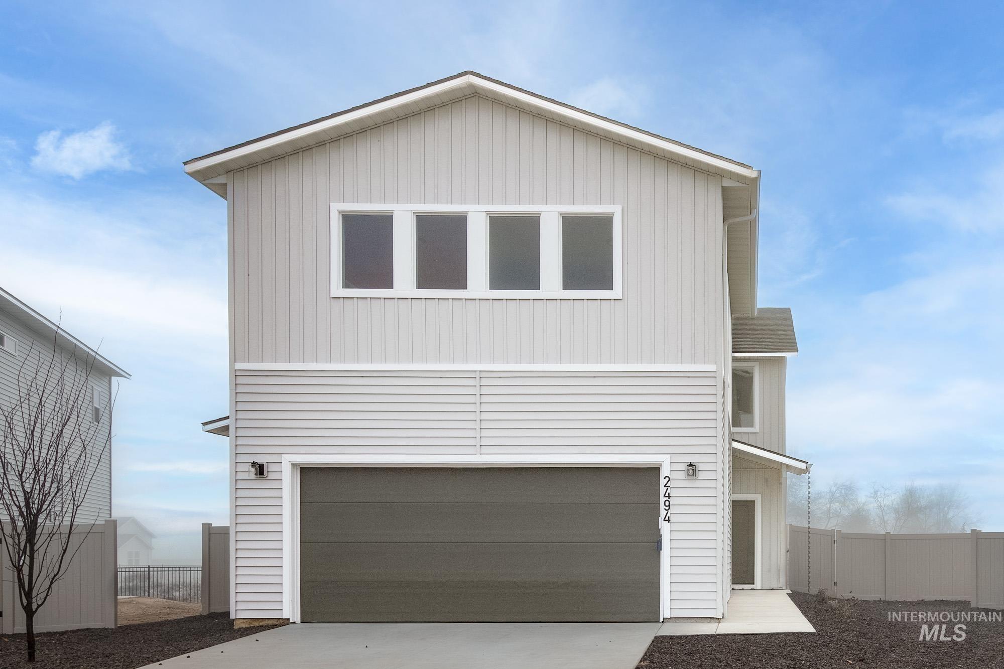 View of front of house with a garage and driveway