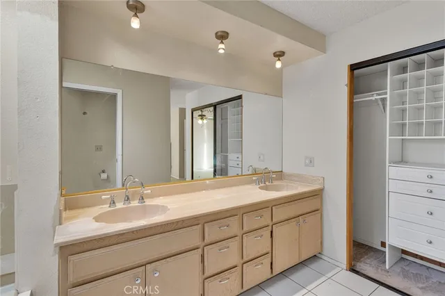 a bathroom with double sink and a mirror