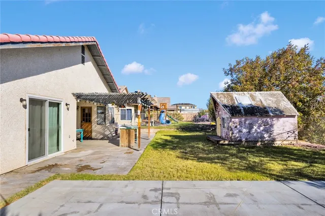 a view of a house with swimming pool and sitting area