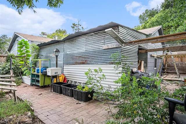 a view of house with backyard and sitting area
