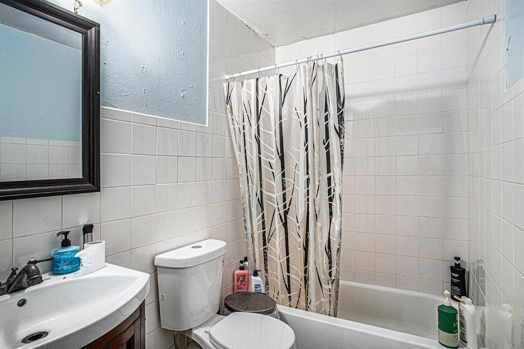 4501 Parrish Road Haltom City, TX 76117 - Photo 6 of 13 a bathroom with a sink toilet and shower