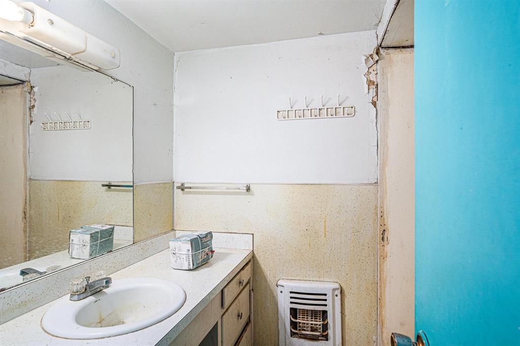 4501 Parrish Road Haltom City, TX 76117 - Photo 8 of 13 a bathroom with a sink a vanity and a mirror