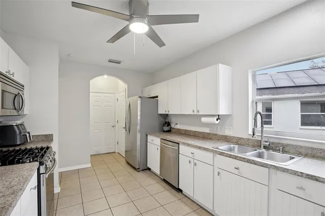 a kitchen with a sink appliances and cabinets