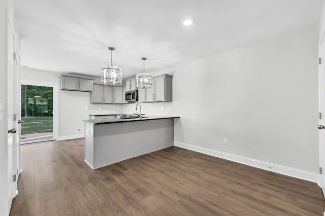 a view of kitchen with granite countertop cabinets and window