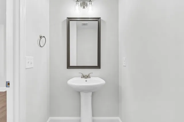 a bathroom with a sink a mirror and shower