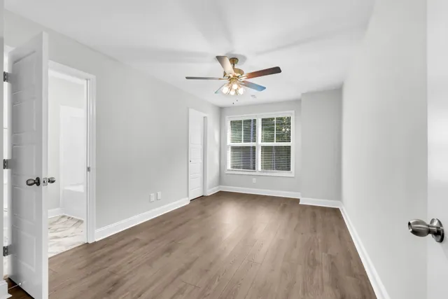 wooden floor in an empty room with a window