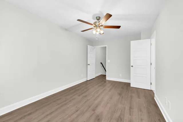 a view of a big room with wooden floor and windows in a room