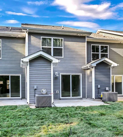 a view of a house with a small yard and a large window