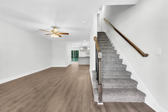 a view of entryway and hall with wooden floor