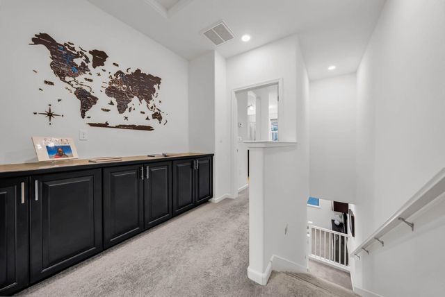 a view of a hallway with wooden floor and stairs