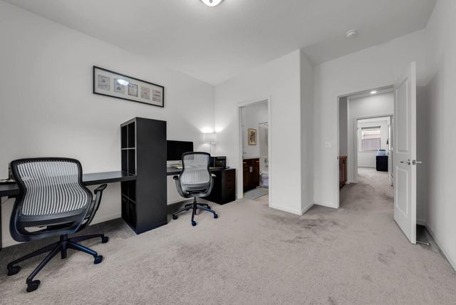 a view of a workspace with furniture and a bathroom