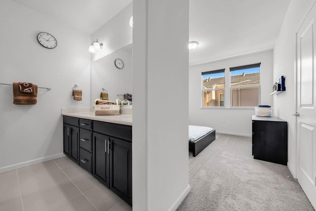 a bathroom with a double vanity sink a mirror and shower