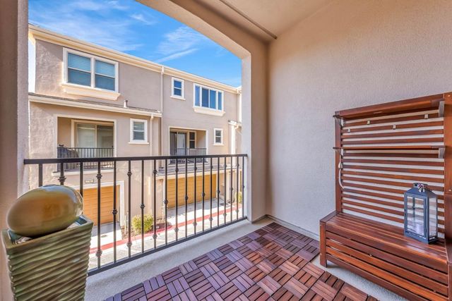 a view of a white house with a big yard and large tree