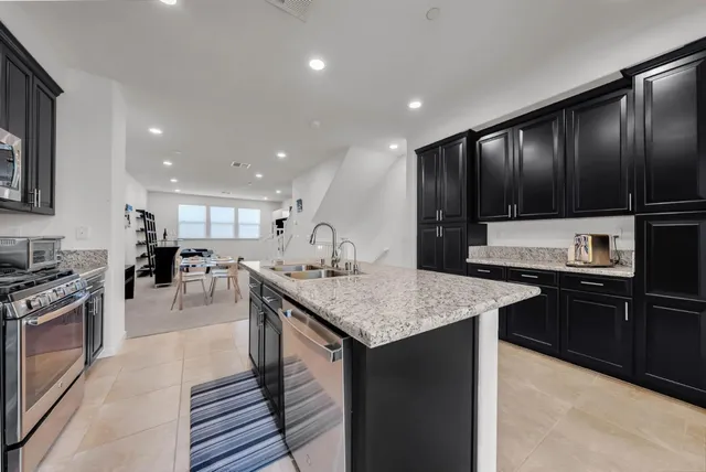 a kitchen with a stove a sink and a refrigerator