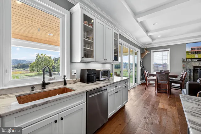 a kitchen with stainless steel appliances granite countertop a sink a stove and a refrigerator