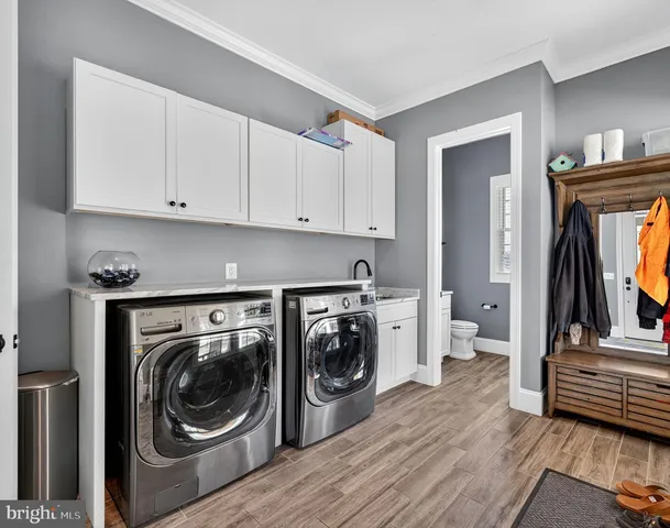 a bathroom with a granite countertop sink toilet and mirror