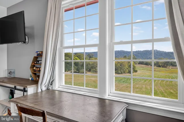 a bathroom with double vanity sinks a vanity a lamp and a shower