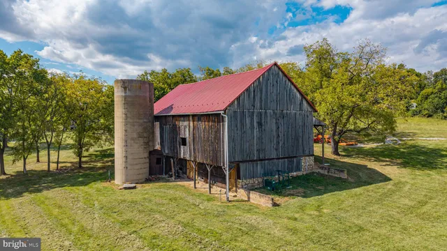 a backyard of a house with a fountain and tree