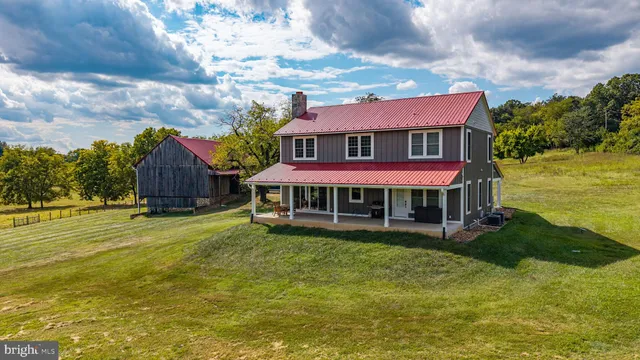 a view of a house with garden and a yard