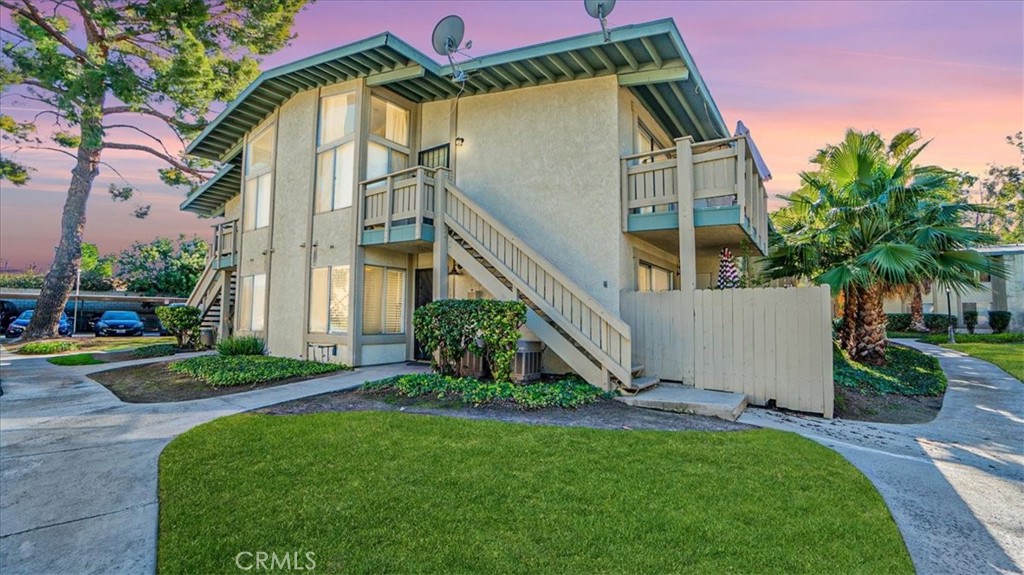 1800 East Old Ranch Road, Unit 131 Colton, CA 92324 - Photo 1 of 1 front view of house with a yard and potted plants