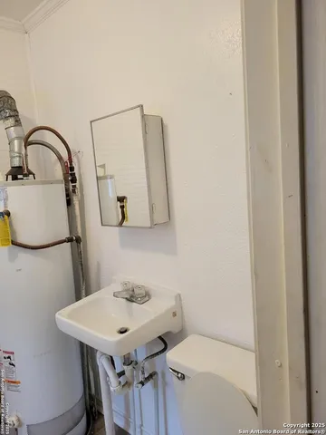 a bathroom with a sink toilet and mirror