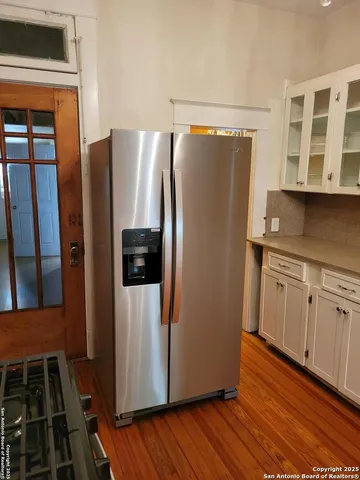 a kitchen with stainless steel appliances a refrigerator and wooden cabinets
