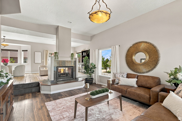 926 Ibis Way Draper, UT 84020 - Photo 2 of 41 Open concept front living room with two sided gas fireplace opening to family room, dining and kitchen